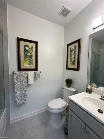 Guest Full bathroom featuring vanity, tiled shower / bath, toilet, and tile patterned floors