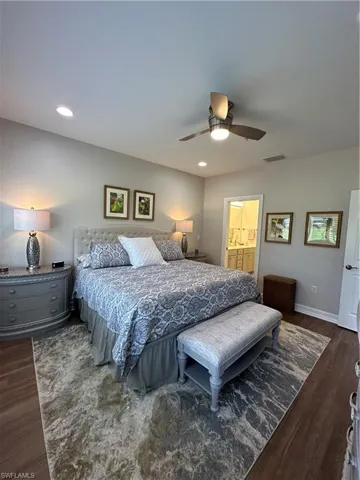 Master Bedroom with dark hardwood / wood-style floors, ensuite bath, and ceiling fan