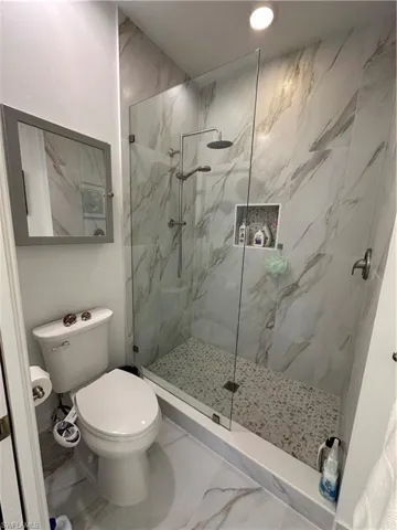 Master Bathroom featuring separate toilet and an enclosed shower