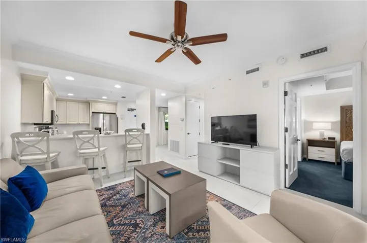 Living room featuring ornamental molding, ceiling fan, and recessed lighting