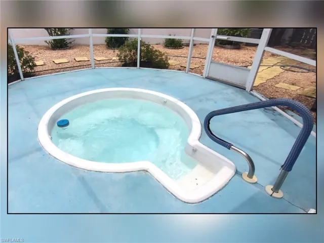 View of swimming pool featuring an in-ground hot tub