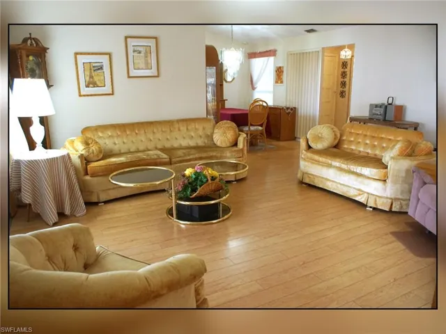 Living area featuring wood-type flooring and a chandelier