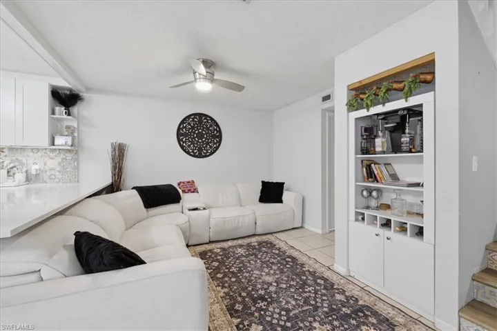 Living area/ custom bar- hallway leads to bathroom and laundry room