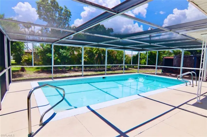Screened pool enclosure featuring an in-ground swimming pool