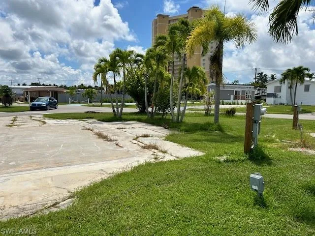 View of home's community with a yard