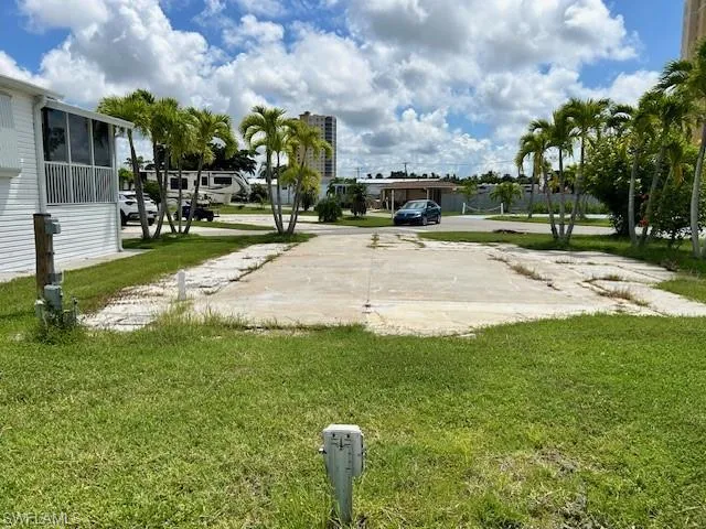 View of property's community with a lawn