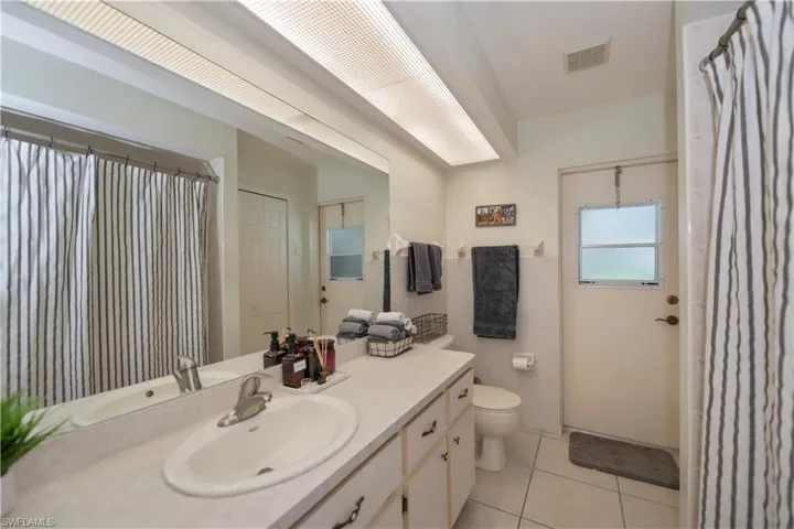 Bathroom with tile patterned flooring, toilet, and vanity