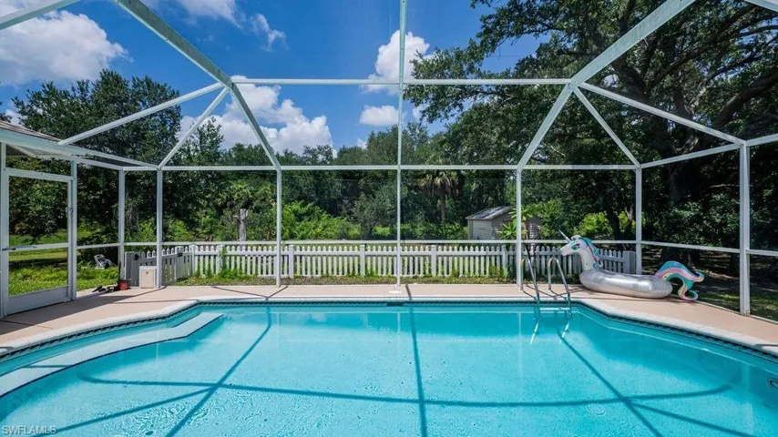 View of swimming pool with glass enclosure