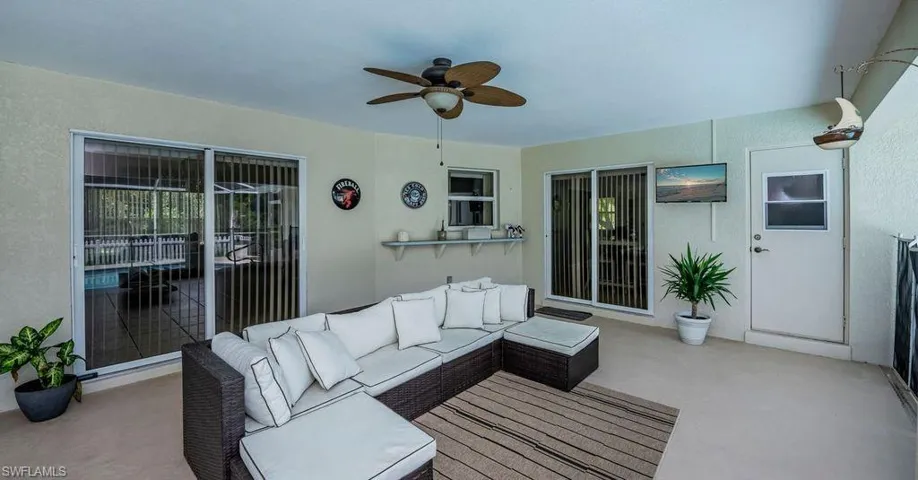 View of patio with outdoor lounge area and ceiling fan