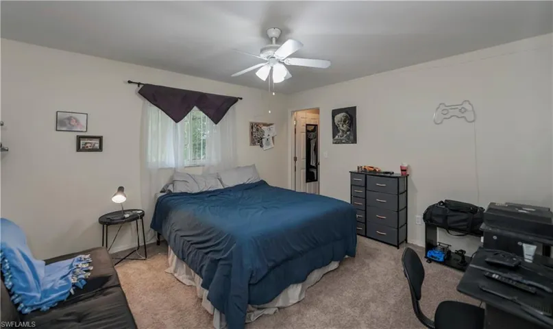 Carpeted bedroom with ceiling fan