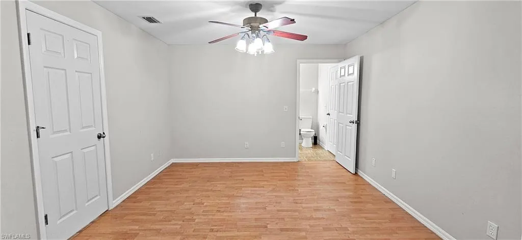 Unfurnished bedroom with light wood-style floors and a ceiling fan
