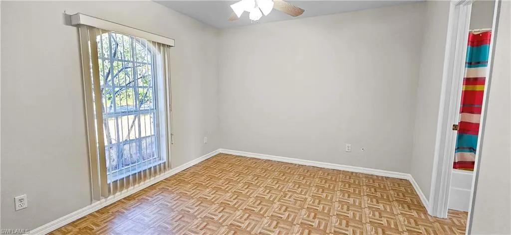 Empty room featuring parquet flooring and ceiling fan
