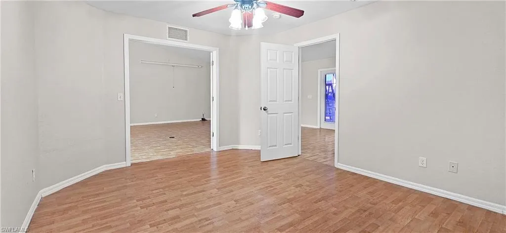 Unfurnished bedroom with light wood-style floors and ceiling fan