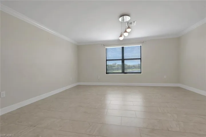 Spare room featuring crown molding