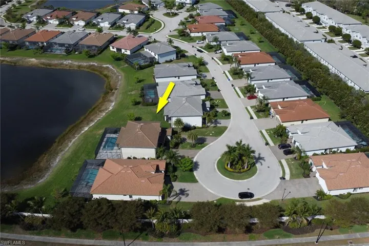 Aerial view of property and surrounding area with nearby suburban area and a nearby body of water