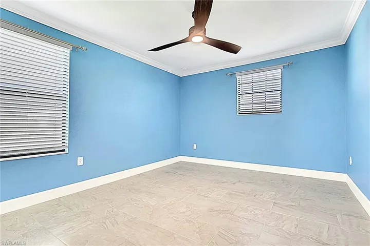Unfurnished room with crown molding and a ceiling fan