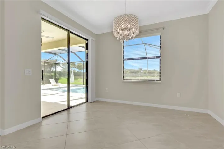 Kitchen / dining area with a chandelier, plenty of natural light, upgraded molding, and light tile patterned flooring and crown molding.