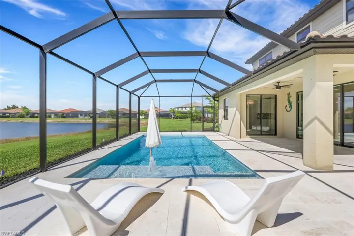 AMAZING SUNSET VIEW FROM YOUR PRIVATE Swimming pool with WATER FEATURE a LARGE COVERED LANIA / PATIO with upgraded SHELL STONE PAVERS,HEATER AND LED LIGHTING