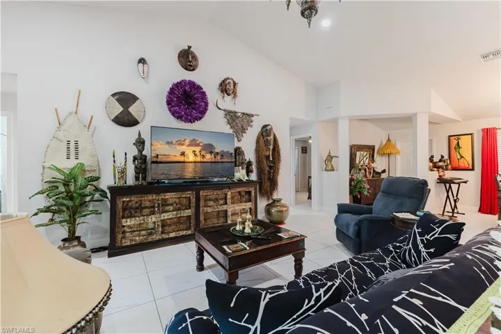 Living area featuring lofted ceiling and light tile patterned floors