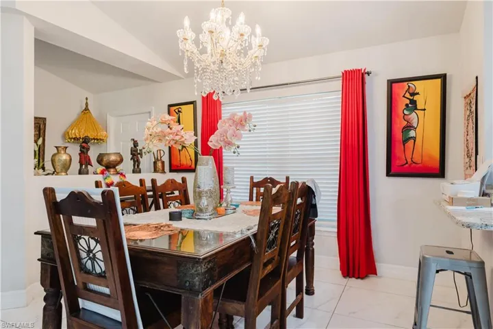 Dining room with a chandelier and baseboards