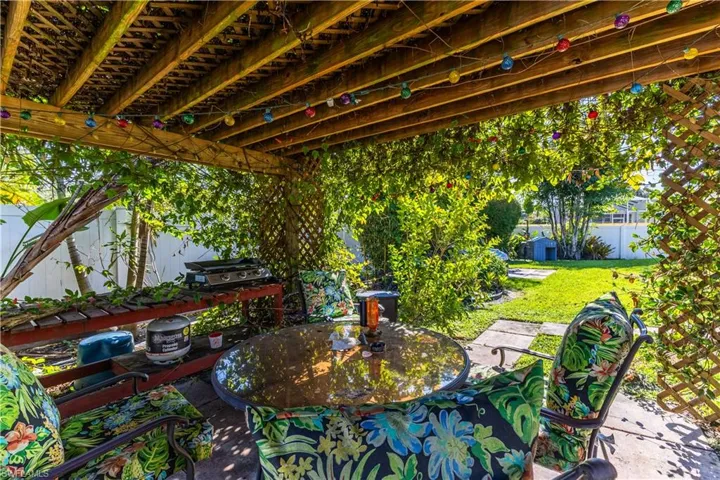 View of patio with outdoor dining area and grilling area