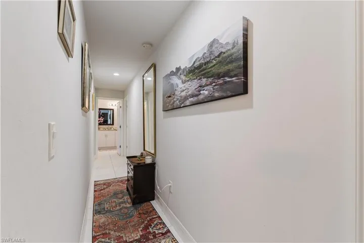 Hall featuring baseboards and recessed lighting