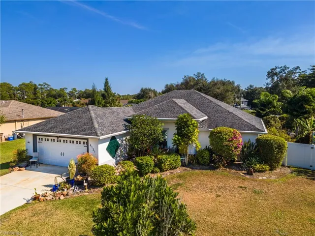 Single story home featuring stucco siding, driveway, an attached garage, and roof with shingles