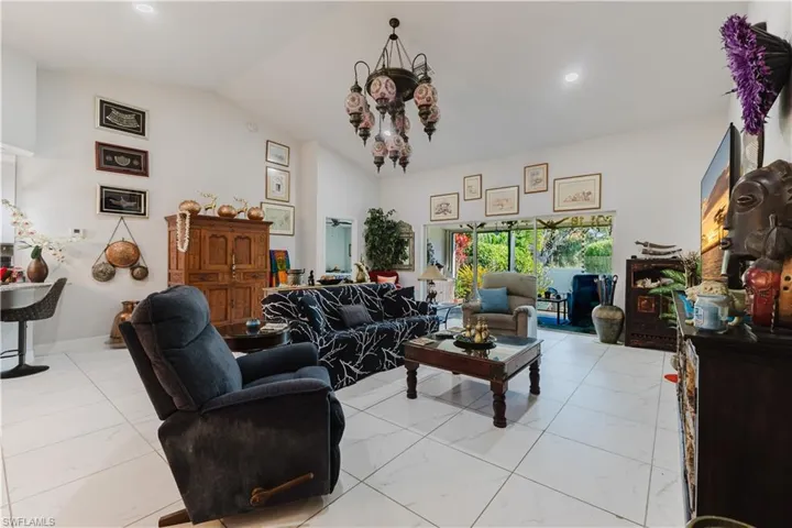 Living room featuring a chandelier and high vaulted ceiling