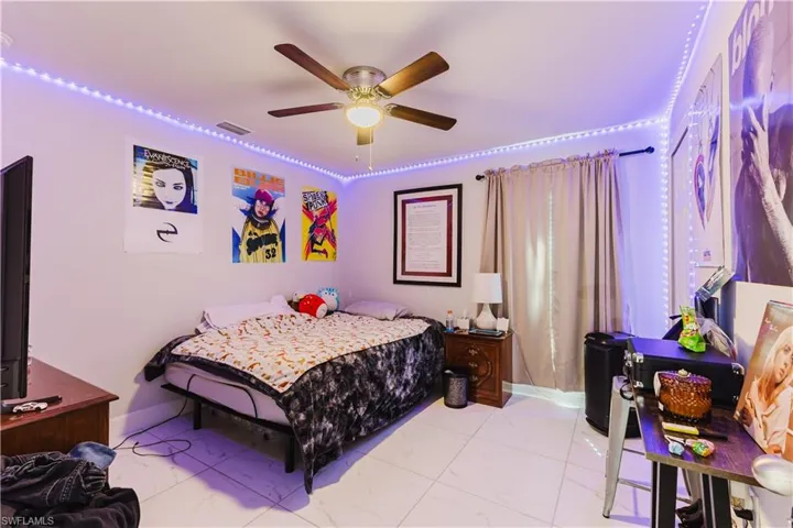 Bedroom featuring a ceiling fan and baseboards