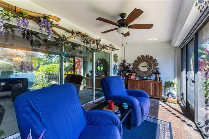 Sunroom featuring a ceiling fan and healthy amount of natural light