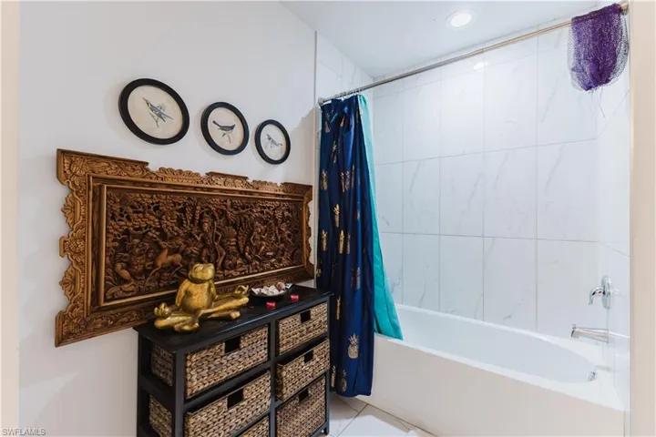 Bathroom with shower / bath combo and tile patterned flooring