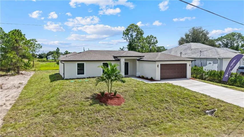 Contemporary single-story residence featuring a two-car garage with a wood-finish door, a concrete driveway, and a shingle roof
