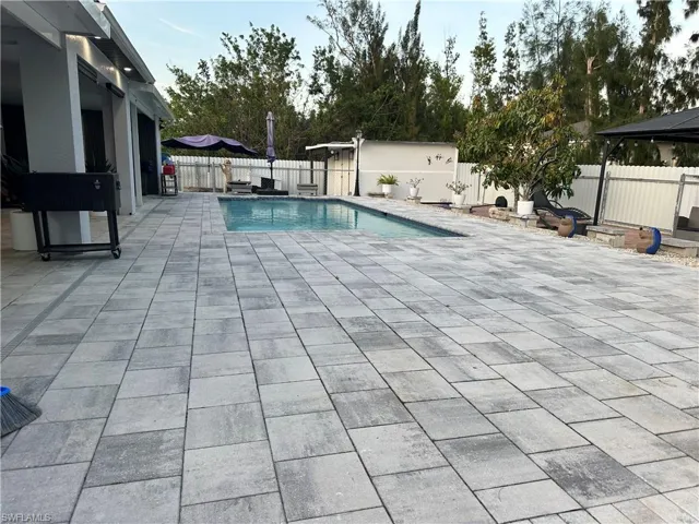 View of swimming pool featuring a fenced in pool, a fenced backyard, and a patio