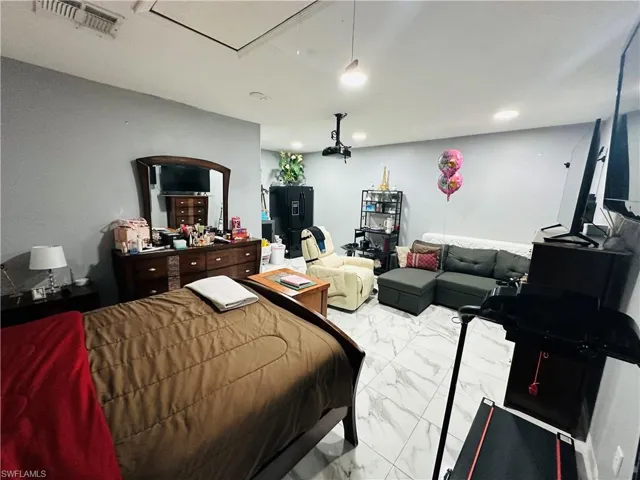 Bedroom featuring marble finish floor, visible vents, and recessed lighting