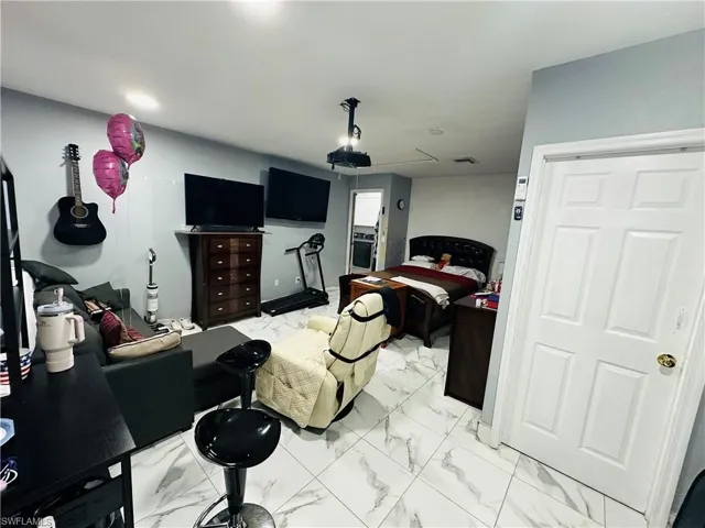 Bedroom with marble finish floor
