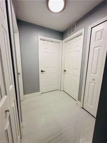 Corridor with visible vents and baseboards