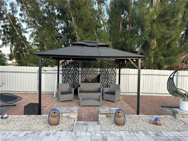 View of patio / terrace featuring a fenced backyard, outdoor lounge area, and a gazebo