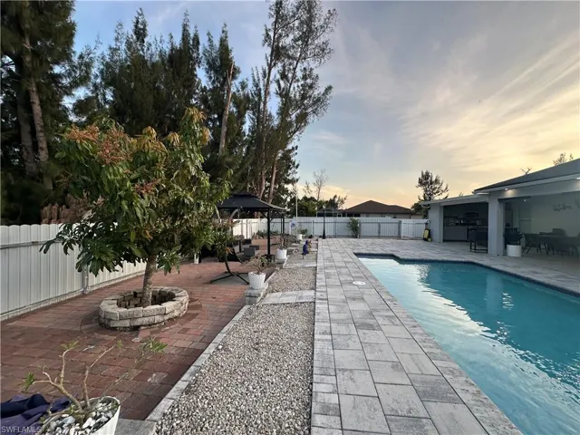 View of pool with a gazebo, a patio area, a fenced backyard, and a fenced in pool