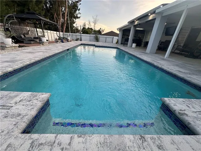 View of pool featuring a fenced backyard, a fenced in pool, and a patio