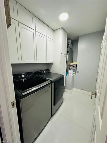 Washroom with cabinet space and independent washer and dryer