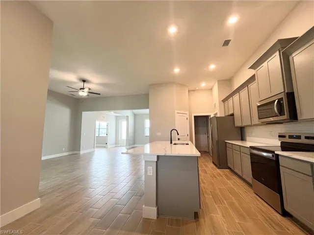 Unfurnished room with light colored carpet and baseboards
