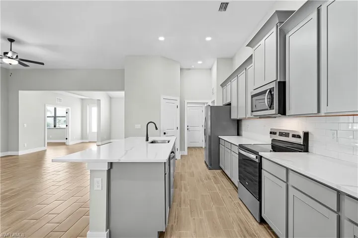 Empty room with wood tiled floors and ceiling fan