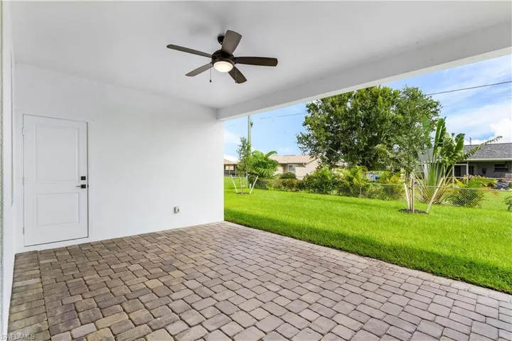 Spare room featuring ceiling fan and brick patterned floors