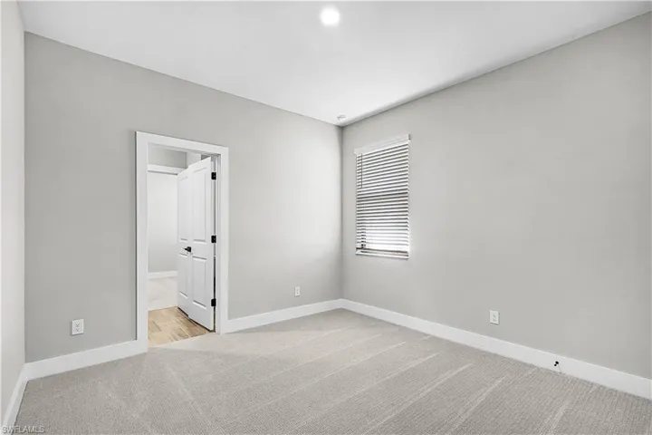 Carpeted spare room with baseboards