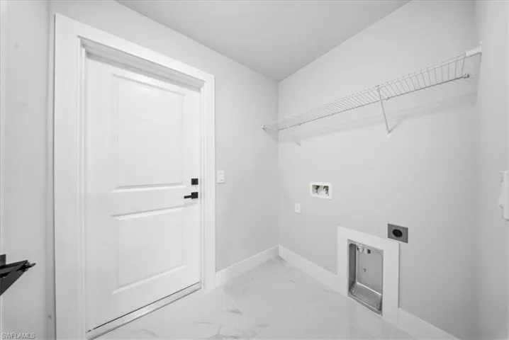 Laundry room featuring light marble finish floors, electric dryer hookup, and washer hookup