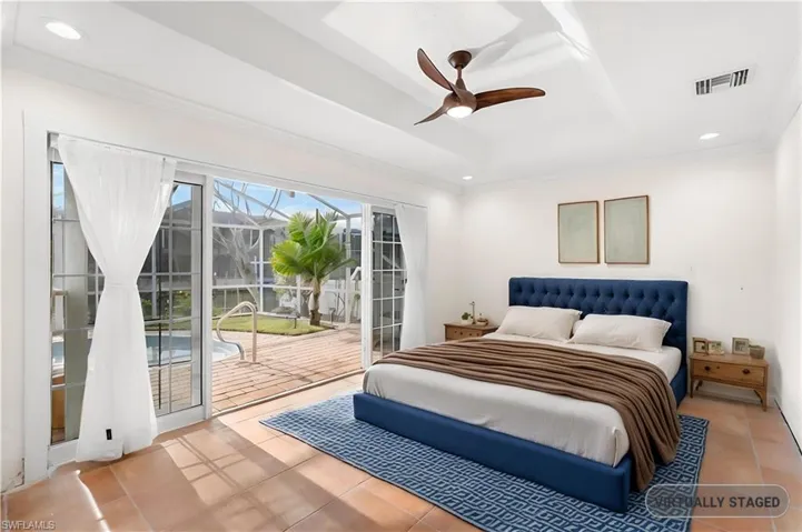 Tiled bedroom featuring access to outside, ceiling fan, and crown molding