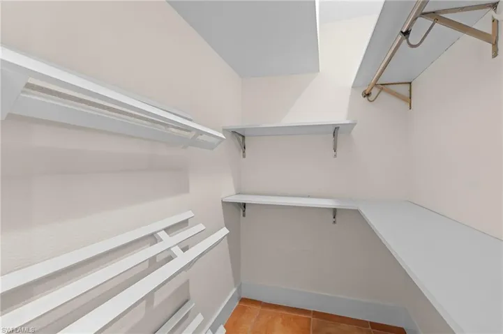 Spacious closet with light tile patterned flooring
