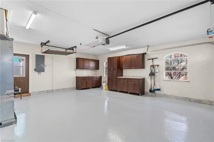Garage with a garage door opener and electric panel