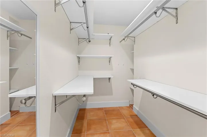 Spacious closet featuring light tile patterned flooring