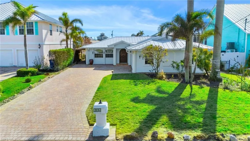 View of front facade with a garage and a front lawn